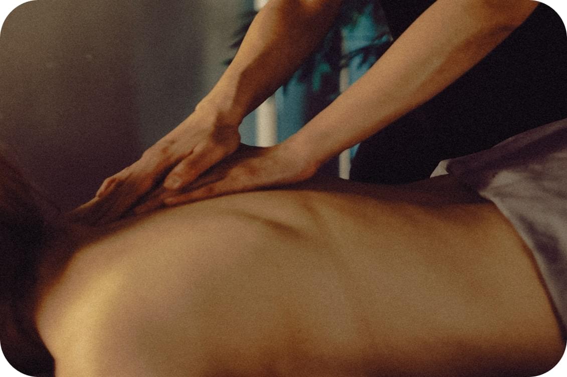 Licensed massage therapist performing deep tissue massage at Renew